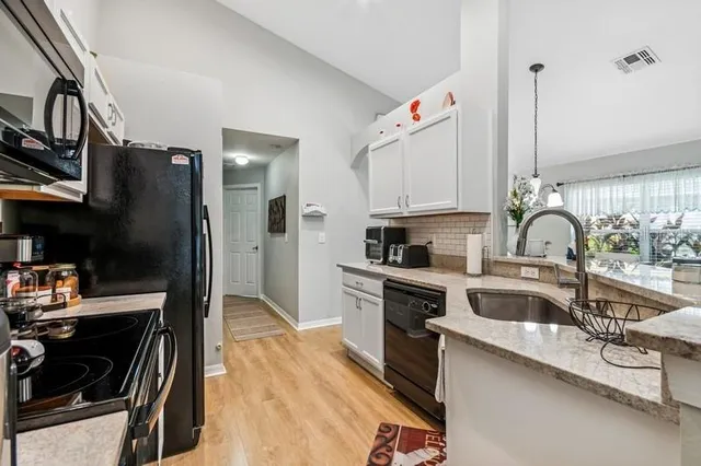 a kitchen with a sink cabinets and appliances