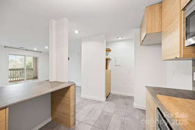 a view of an entryway with wooden floor and a cabinet