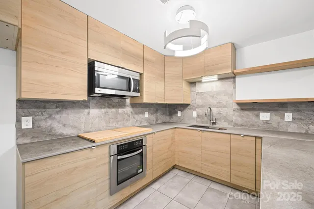 a kitchen with a sink cabinets and appliances