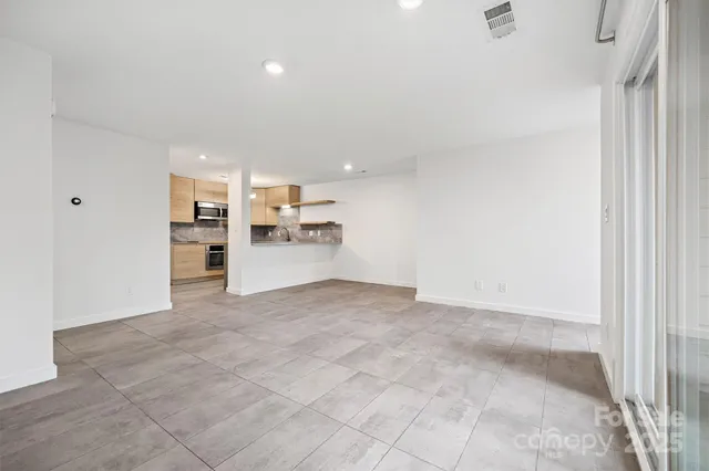 a view of a kitchen with a sink and cabinets