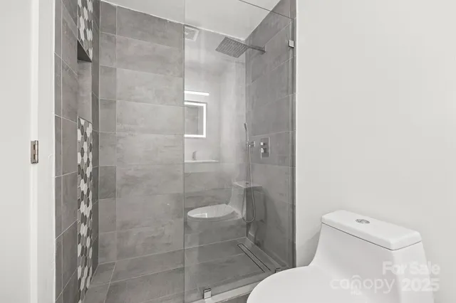 a white toilet sitting next to a bathroom sink