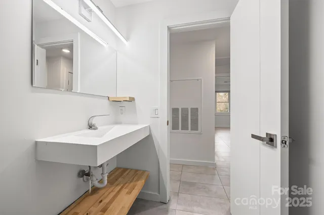 a bathroom with a sink and mirror