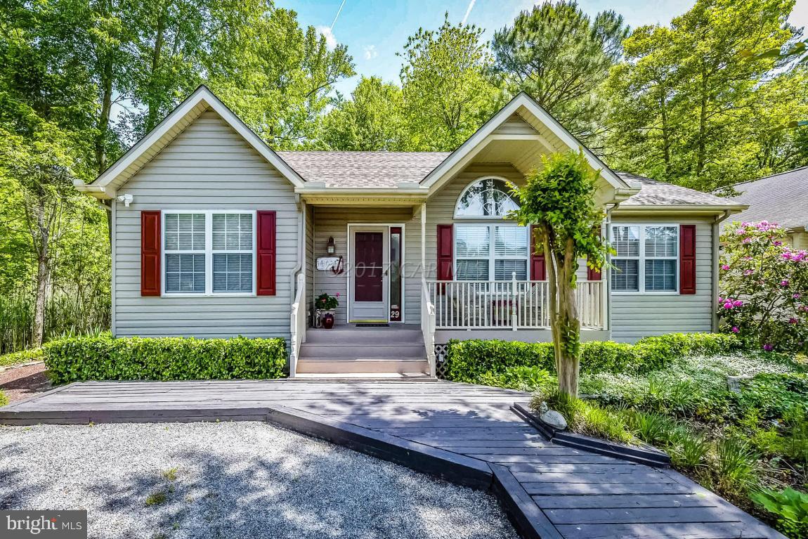 29 Watertown Road Ocean Pines, MD 21811 - Photo 1 of 49 a front view of a house with a yard and potted plants