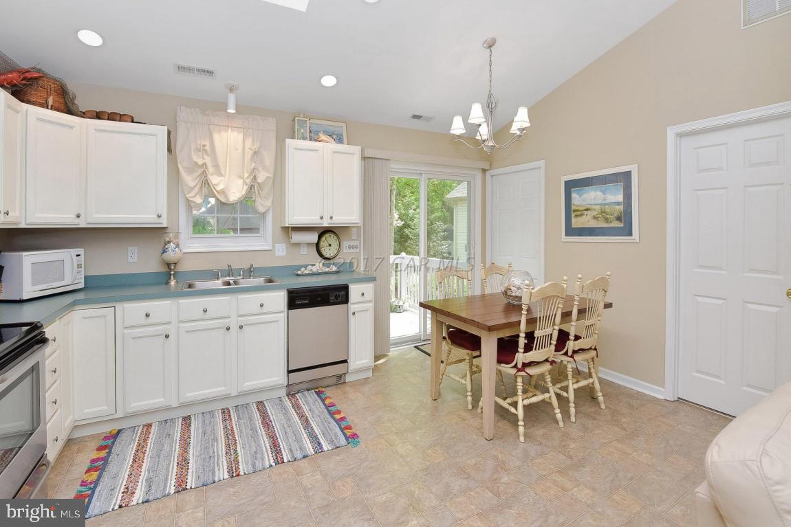 29 Watertown Road Ocean Pines, MD 21811 - Photo 13 of 49 a kitchen with granite countertop furniture dining table and stainless steel appliances