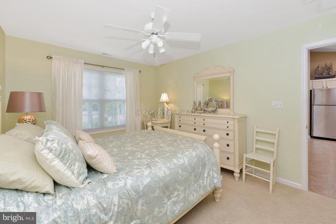 29 Watertown Road Ocean Pines, MD 21811 - Photo 18 of 49 a bedroom with a bed and a chandelier