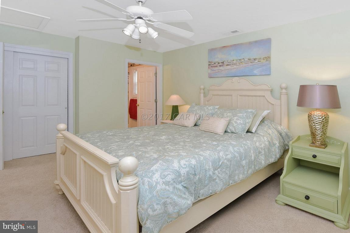 29 Watertown Road Ocean Pines, MD 21811 - Photo 19 of 49 a bedroom with a bed and a chandelier