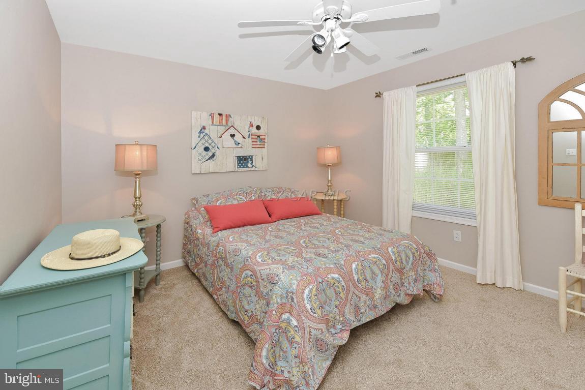 29 Watertown Road Ocean Pines, MD 21811 - Photo 22 of 49 a bedroom with a bed and a painting on the wall