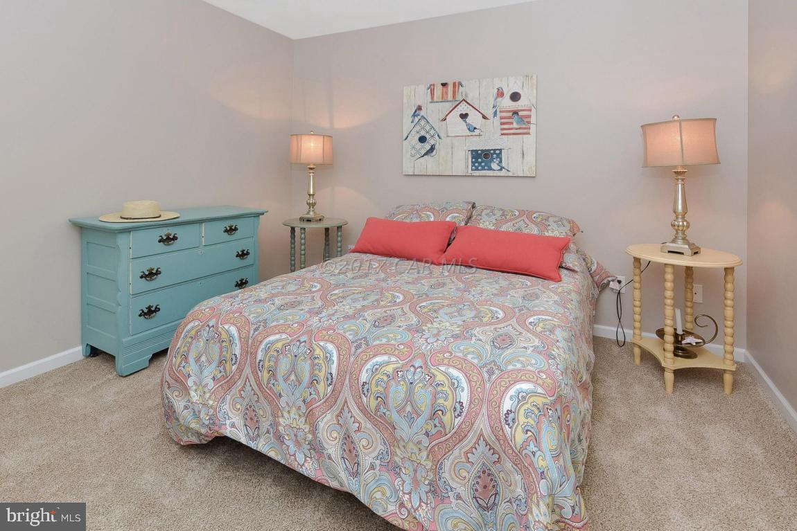 29 Watertown Road Ocean Pines, MD 21811 - Photo 24 of 49 a bedroom with a bed and a lamp on dresser