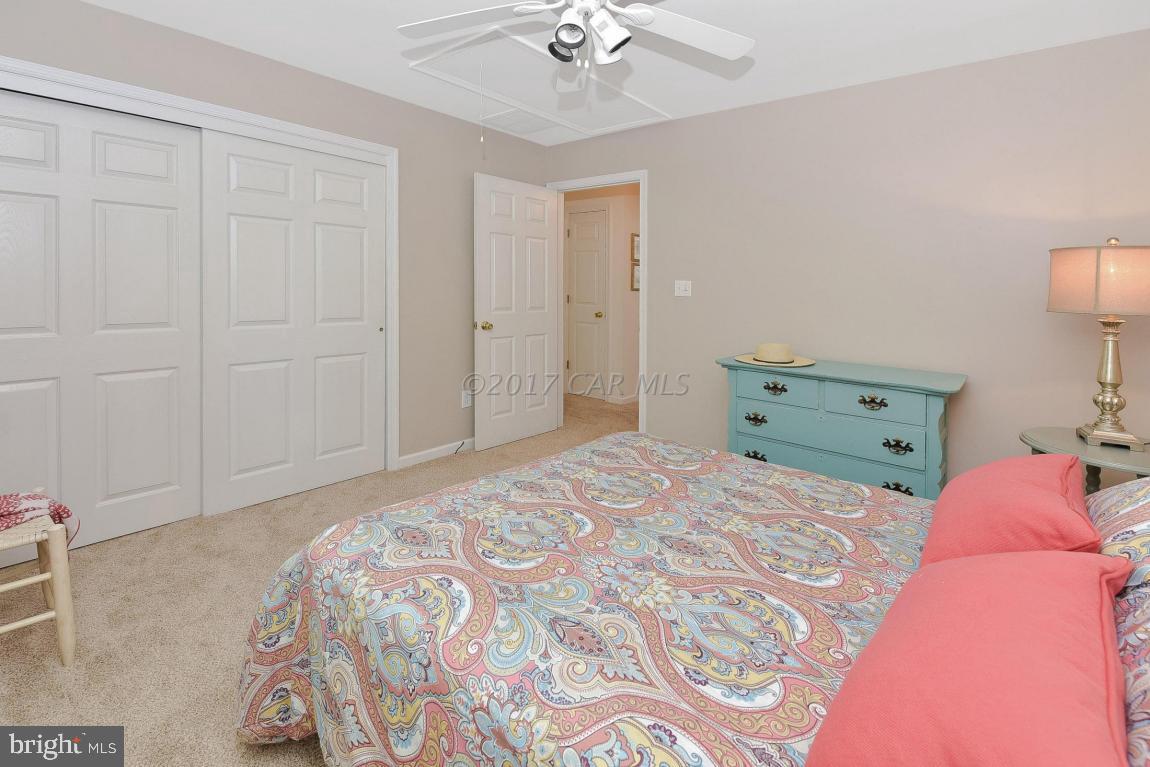 29 Watertown Road Ocean Pines, MD 21811 - Photo 25 of 49 a bedroom with a bed and a chandelier