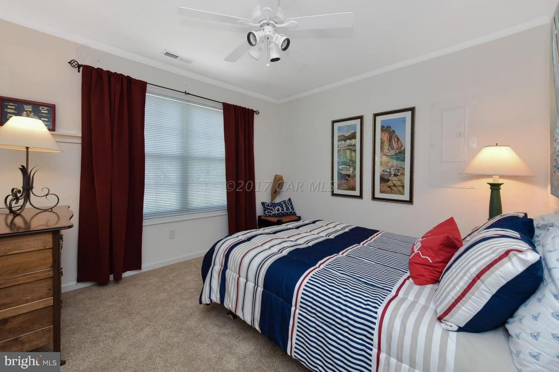 29 Watertown Road Ocean Pines, MD 21811 - Photo 27 of 49 a bedroom with a bed and a lamp