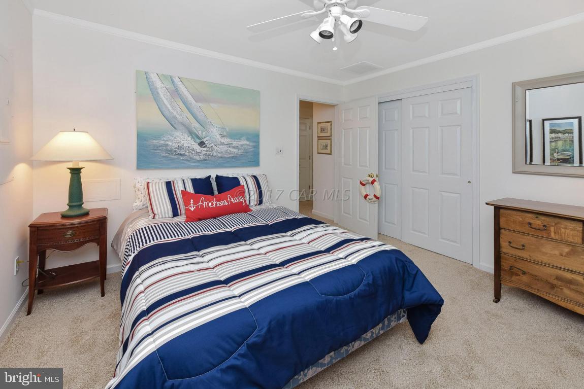 29 Watertown Road Ocean Pines, MD 21811 - Photo 29 of 49 a bedroom with a bed and a lamp