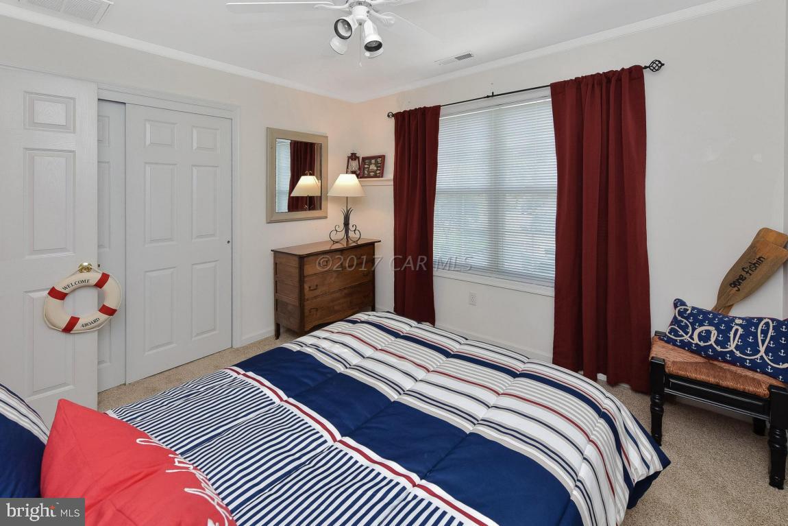 29 Watertown Road Ocean Pines, MD 21811 - Photo 30 of 49 a bedroom with a bed and wooden floor