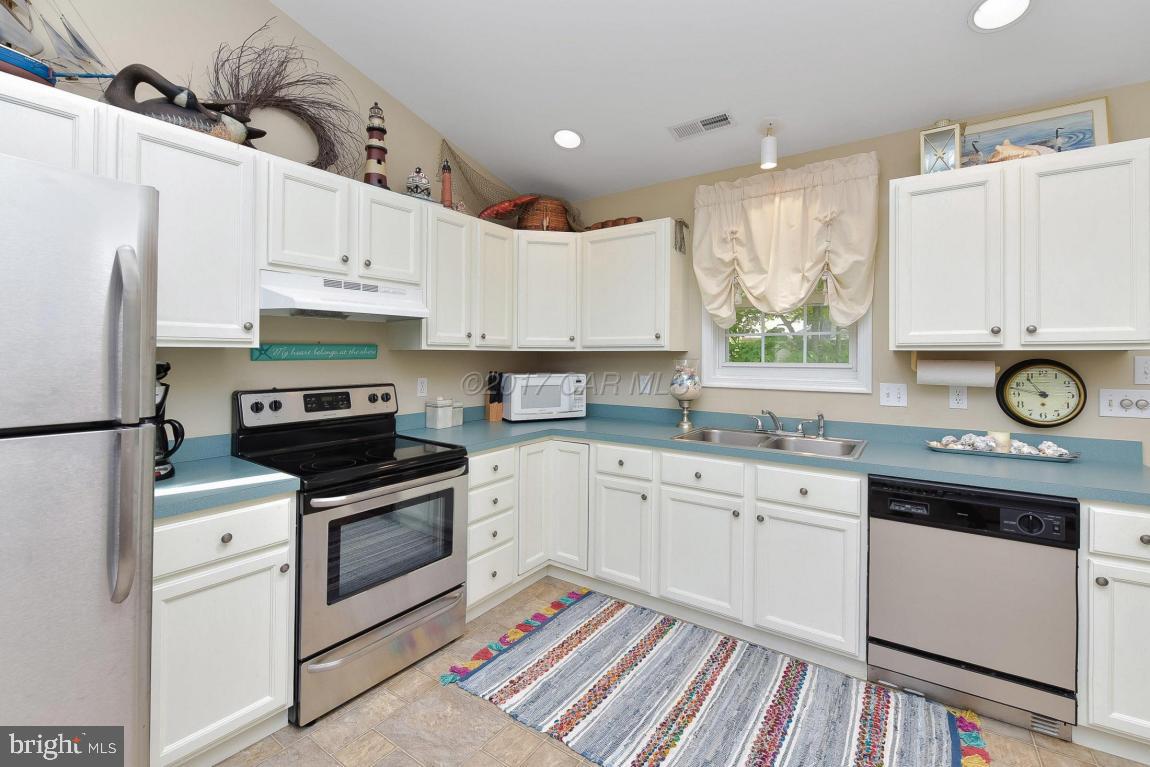 29 Watertown Road Ocean Pines, MD 21811 - Photo 8 of 49 a kitchen with granite countertop white cabinets white stainless steel appliances and sink