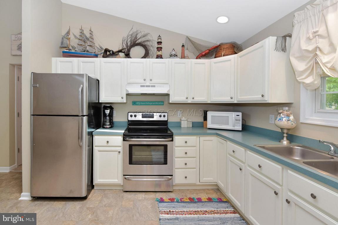 29 Watertown Road Ocean Pines, MD 21811 - Photo 9 of 49 a kitchen with stainless steel appliances granite countertop a refrigerator sink and stove