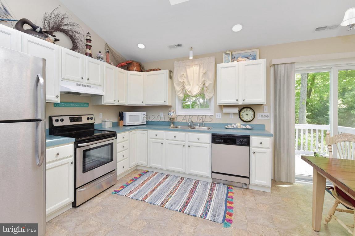 29 Watertown Road Ocean Pines, MD 21811 - Photo 10 of 49 a kitchen with a white stove top oven and refrigerator
