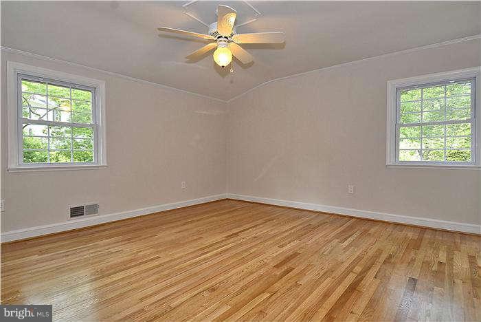 3216 Park View Road Chevy Chase, MD 20815 - Photo 20 of 29 a view of an empty room with wooden floor and a window