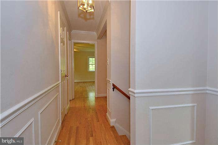 3216 Park View Road Chevy Chase, MD 20815 - Photo 23 of 29 a view of a hallway with wooden floor and a bathroom