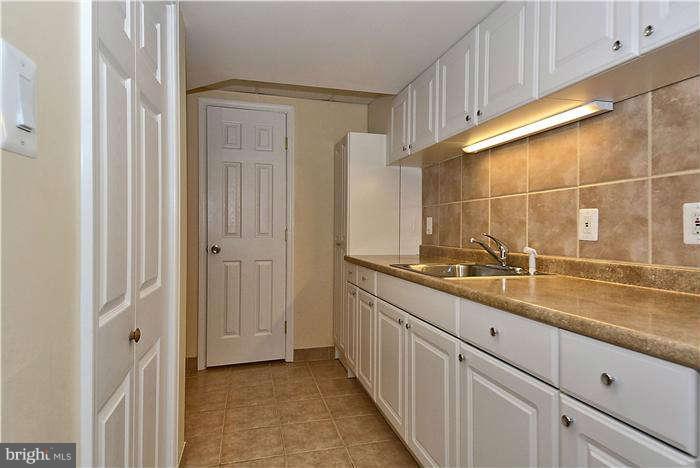 3216 Park View Road Chevy Chase, MD 20815 - Photo 27 of 29 a bathroom with a sink and a mirror