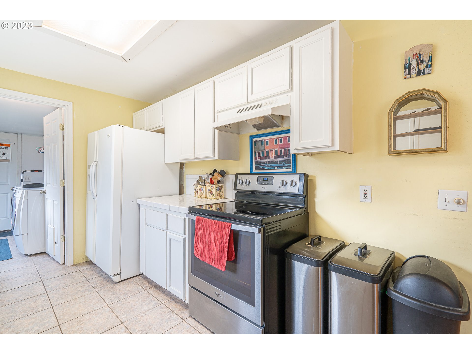 471 West M Street Springfield, OR 97477 - Photo 12 of 37 a kitchen with stainless steel appliances granite countertop a stove a refrigerator and a microwave