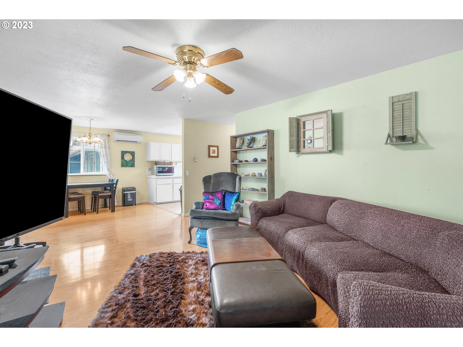 471 West M Street Springfield, OR 97477 - Photo 4 of 37 a living room with furniture and a flat screen tv