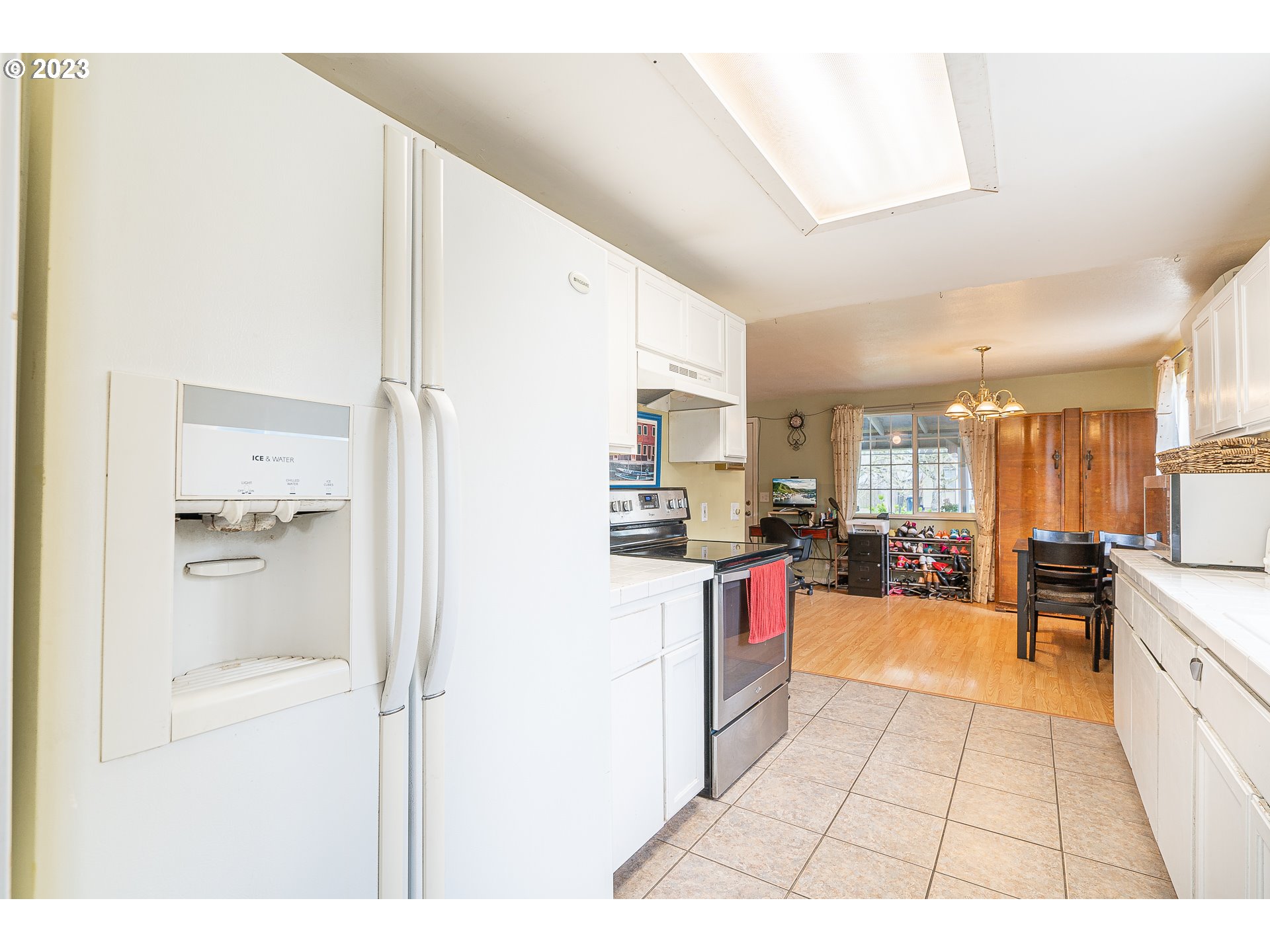 471 West M Street Springfield, OR 97477 - Photo 9 of 37 a open kitchen with stainless steel appliances kitchen island granite countertop a refrigerator a stove a sink dishwasher with a dining table and chairs