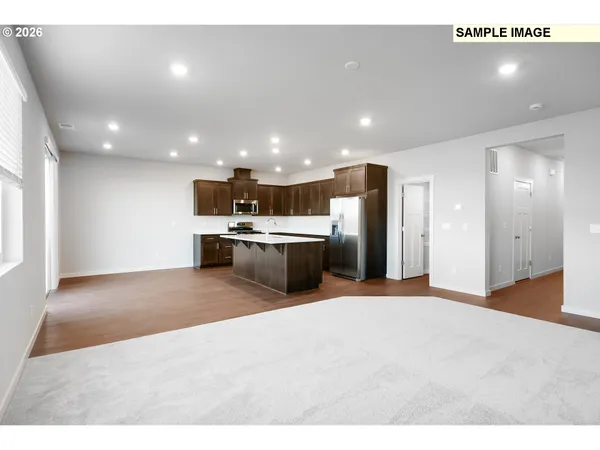 a view of a kitchen with a sink and a refrigerator