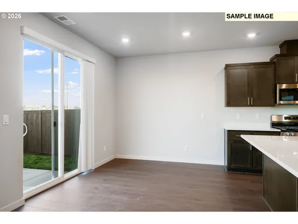 a view of a kitchen with a sink and microwave