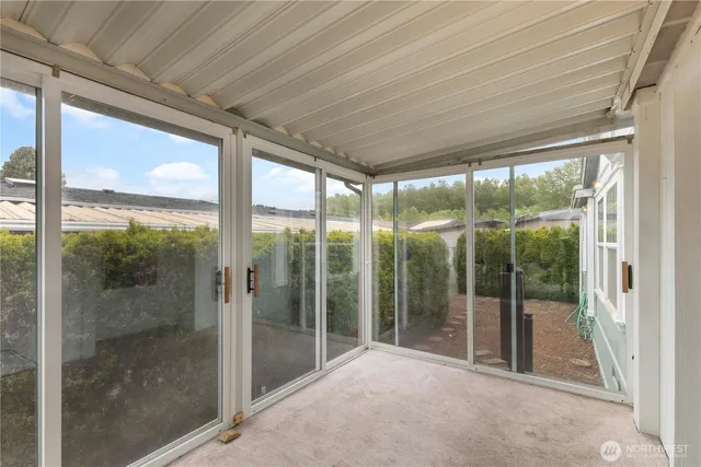 a view of pool with umbrella and wooden fence