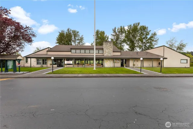 a view of a house with a yard and sitting area
