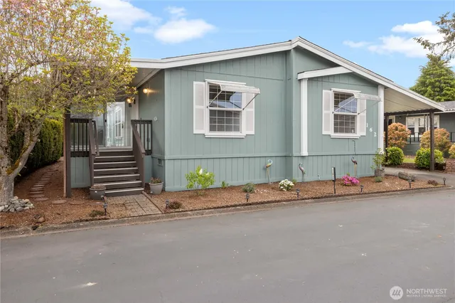 a front view of a house with a road