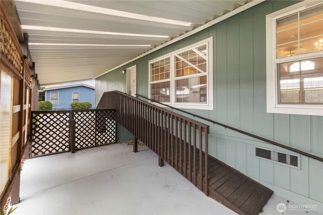 a view of an empty room with window and cabinet