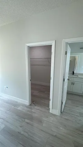 a bathroom with a double vanity sink and mirror with bathtub