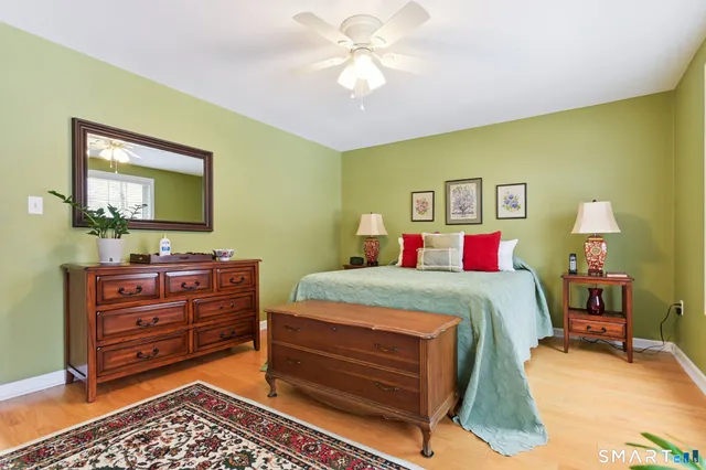 a bed room with a bed and a mirror