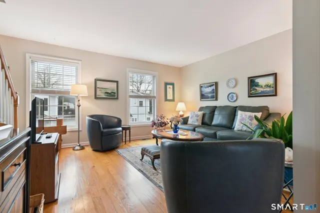 a living room with furniture a fireplace and a window