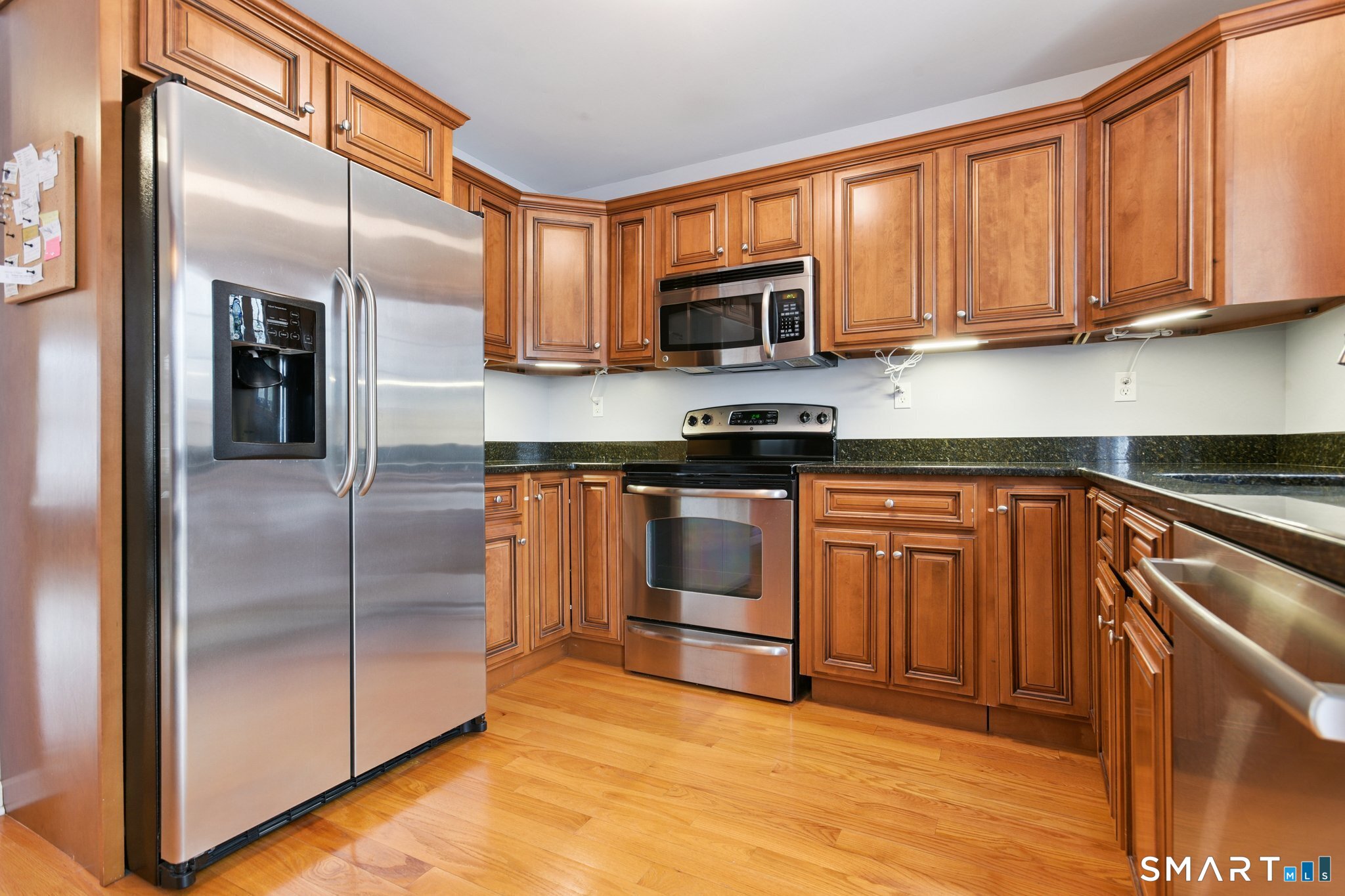 2 Bull Avenue, Unit A3 Wallingford, CT 06492 - Photo 9 of 23 a kitchen with stainless steel appliances granite countertop a stove a sink and a refrigerator