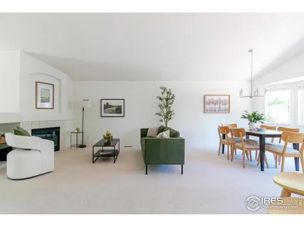 a living room with furniture a dining table and a fireplace