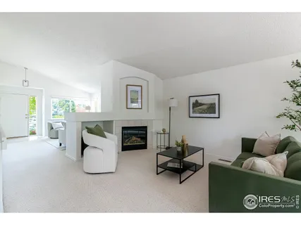 a living room with furniture a fireplace and a table