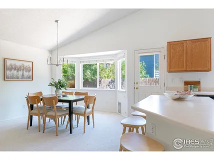 a view of a dining room with furniture and a chandelier
