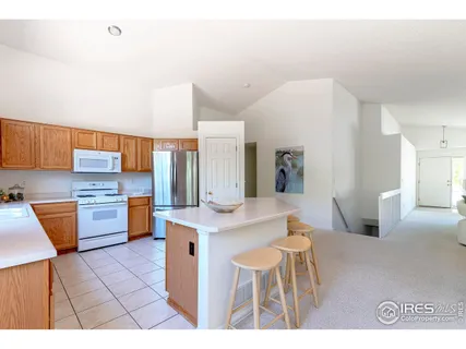 a kitchen with stainless steel appliances a sink a counter top space and cabinets