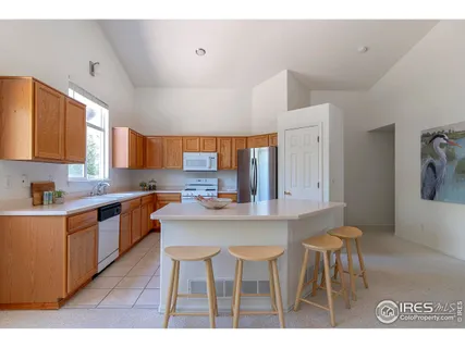 a kitchen with stainless steel appliances kitchen island granite countertop a sink and cabinets