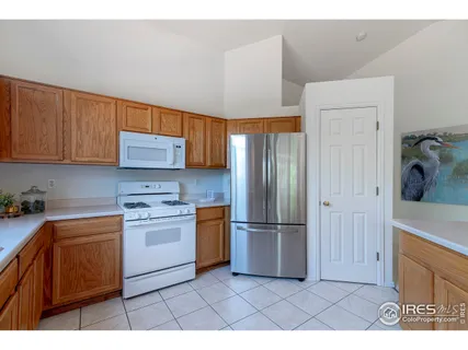 a kitchen with stainless steel appliances granite countertop a refrigerator sink and cabinets
