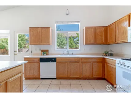 a kitchen with stainless steel appliances kitchen island granite countertop a sink a stove a counter top space and cabinets
