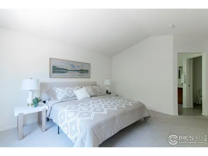 a bedroom with a bed and a painting on the wall