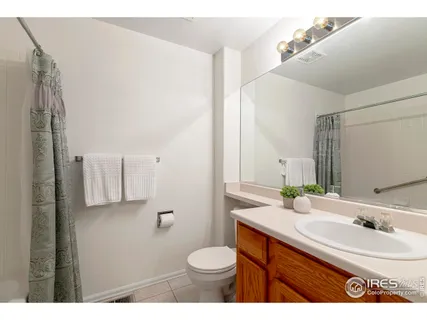 a bathroom with a sink toilet and mirror
