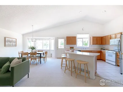 a living room with furniture a dining table and a wooden floor