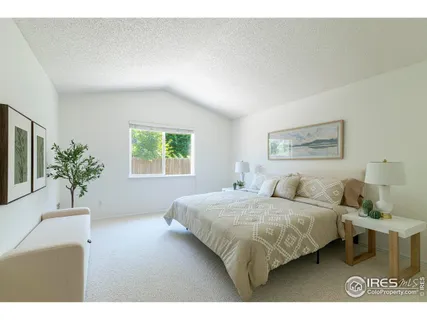 a bedroom with bed and a potted plant
