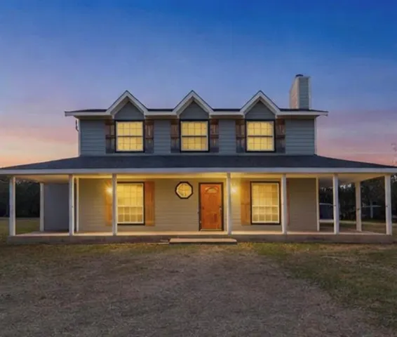 a front view of a house with yard