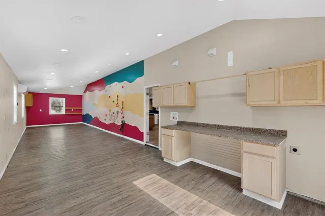 a view of a kitchen with stainless steel appliances granite countertop a stove a sink and a refrigerator