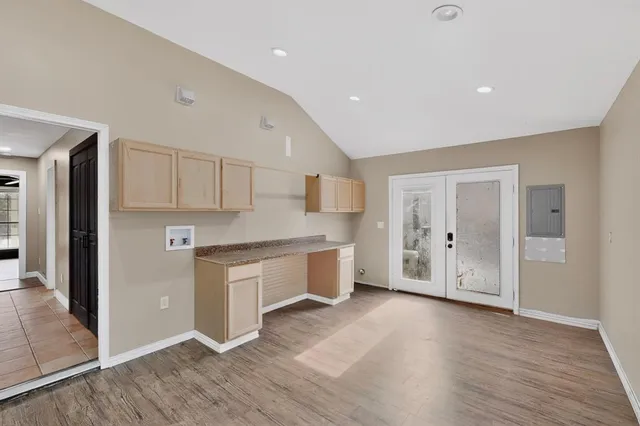 a large kitchen with a lot of counter space and stainless steel appliances