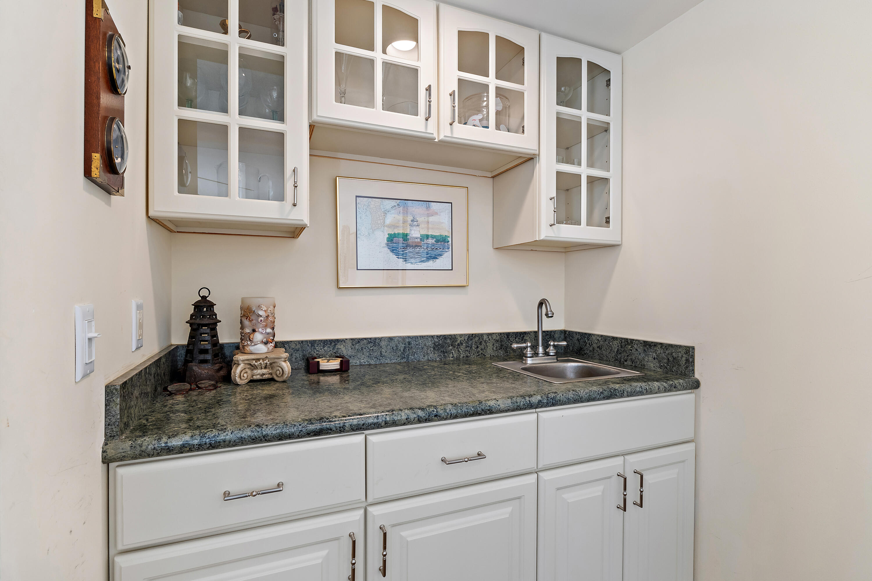 1420 Ocean Way, Unit 28D Jupiter, FL 33477 - Photo 15 of 33 a kitchen with granite countertop cabinets and window